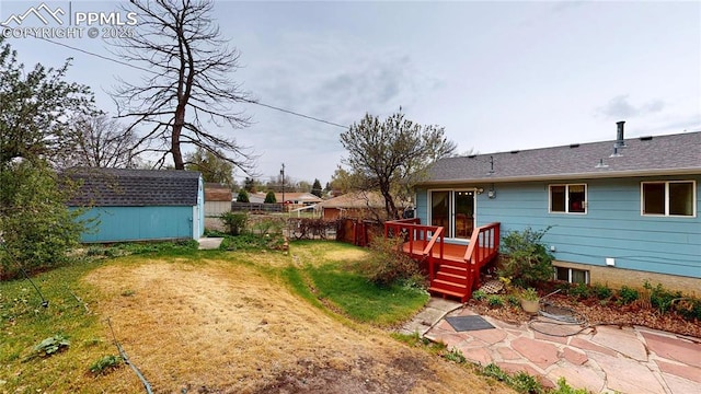 4012 Maxwell Pl, Colorado Springs, CO 80909 - back of property with a deck, an outdoor structure, and a storage unit