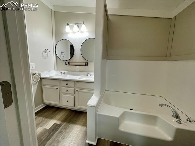 17940 Countdown Dr, Peyton, CO 80831 - full bathroom featuring wood finished floors, a tub, and double vanity