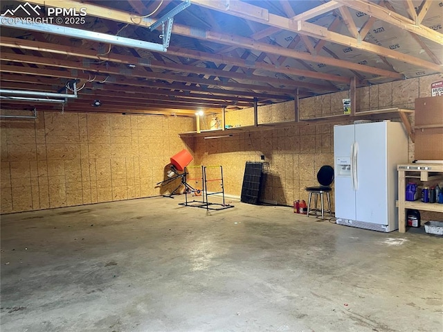 17940 Countdown Dr, Peyton, CO 80831 - garage with white refrigerator with ice dispenser