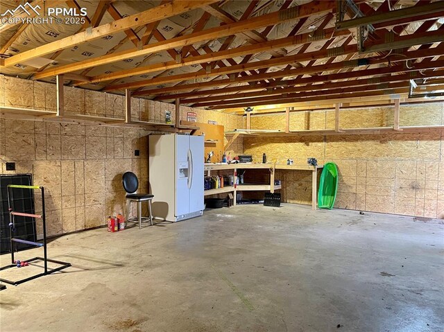 17940 Countdown Dr, Peyton, CO 80831 - garage with white fridge with ice dispenser
