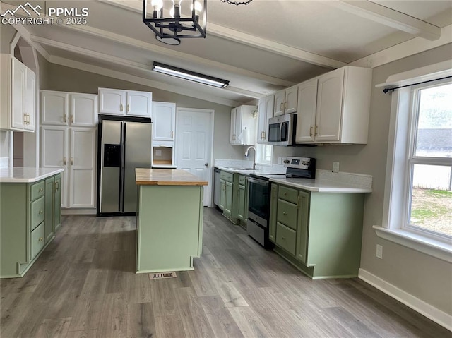 17940 Countdown Dr, Peyton, CO 80831 - kitchen featuring green cabinets, appliances with stainless steel finishes, a sink, butcher block countertops, and light wood-style flooring