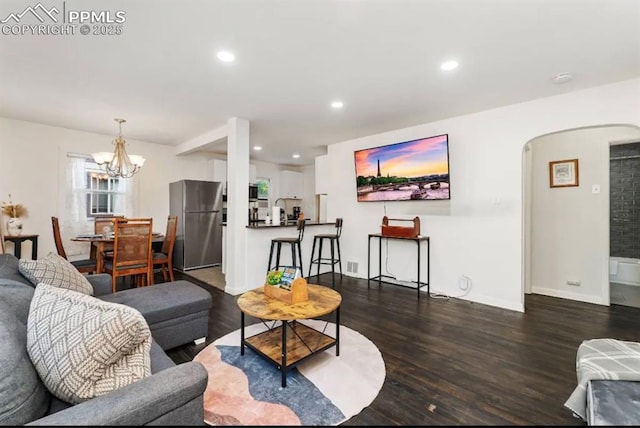 739 S Utica St, Denver, CO 80219 - living area with wood finished floors, a chandelier, arched walkways, recessed lighting, and baseboards
