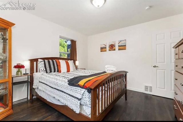739 S Utica St, Denver, CO 80219 - bedroom with dark wood-style flooring and baseboards