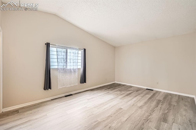 4790 Hennings Dr, Colorado Springs, CO 80911 - unfurnished room featuring light wood-style flooring, lofted ceiling, a textured ceiling, and baseboards