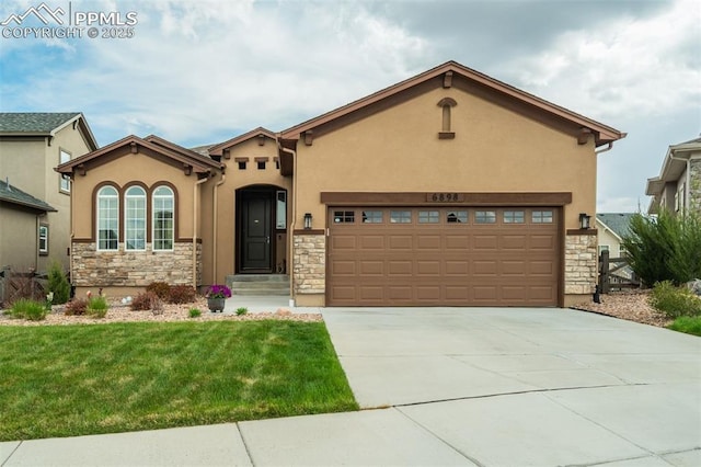 6898 Sedgerock Ln, Colorado Springs, CO 80927 - mediterranean / spanish house featuring stone siding, a front yard, stucco siding, and concrete driveway