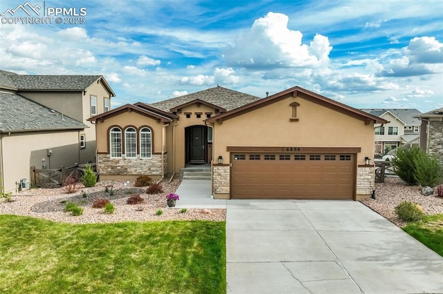 6898 Sedgerock Ln, Colorado Springs, CO 80927 - view of front of property featuring stone siding, stucco siding, an attached garage, and a front yard