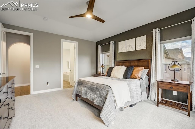 6898 Sedgerock Ln, Colorado Springs, CO 80927 - bedroom with light colored carpet, baseboards, ensuite bath, and ceiling fan