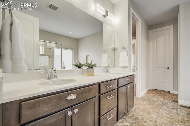6898 Sedgerock Ln, Colorado Springs, CO 80927 - full bath with double vanity, a stall shower, and baseboards