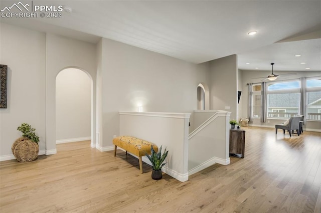 6898 Sedgerock Ln, Colorado Springs, CO 80927 - hallway with arched walkways, light wood-style floors, baseboards, recessed lighting, and an upstairs landing