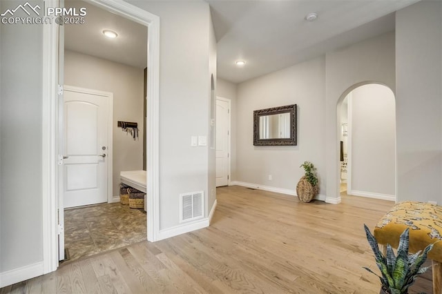 6898 Sedgerock Ln, Colorado Springs, CO 80927 - corridor with arched walkways, light wood-type flooring, baseboards, and recessed lighting