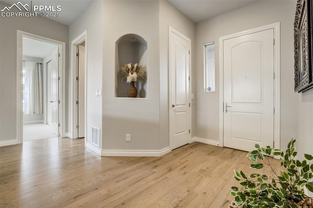 6898 Sedgerock Ln, Colorado Springs, CO 80927 - foyer entrance with light wood-style floors and baseboards