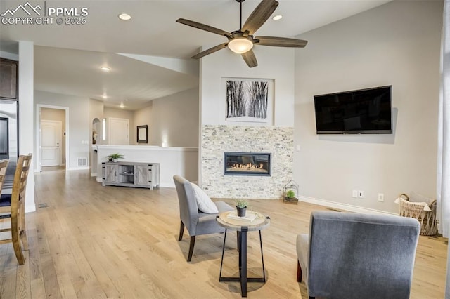 6898 Sedgerock Ln, Colorado Springs, CO 80927 - living room with a ceiling fan, light wood-style floors, a tile fireplace, baseboards, and recessed lighting