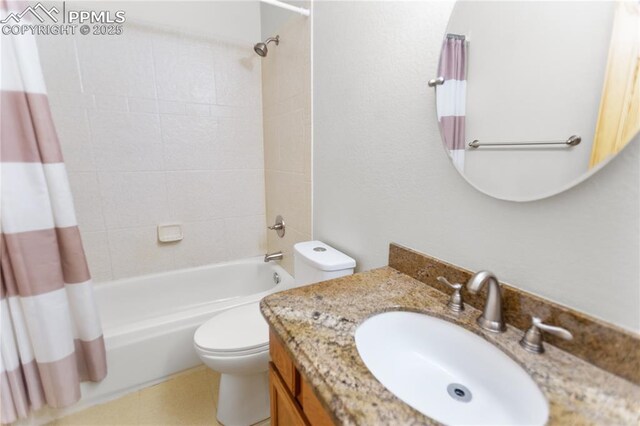 full bath featuring toilet, shower / bathtub combination with curtain, and vanity