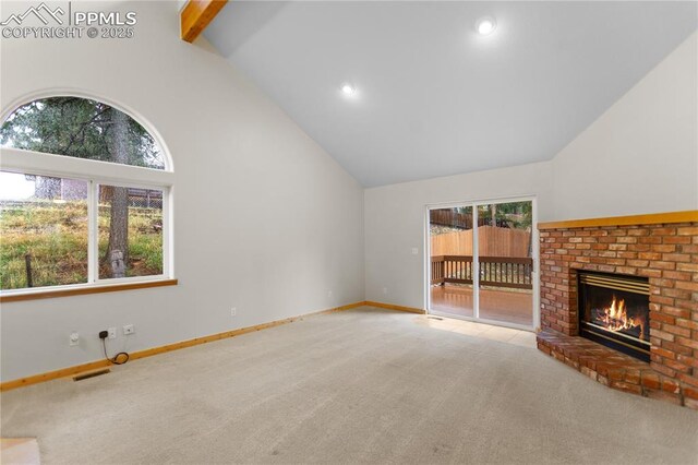 unfurnished living room featuring carpet, a brick fireplace, beam ceiling, baseboards, and high vaulted ceiling