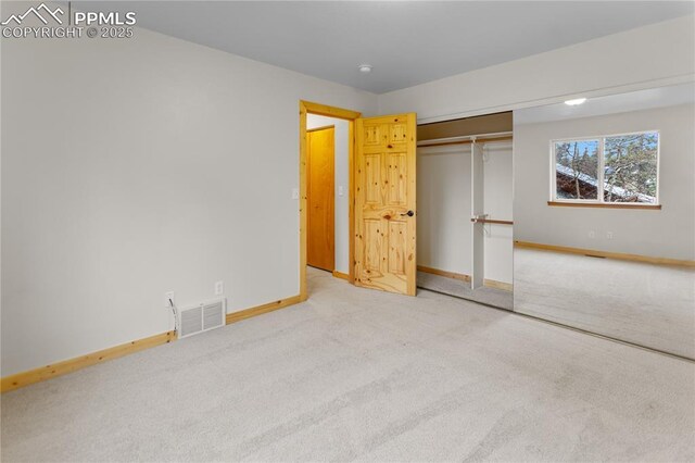 unfurnished bedroom featuring carpet floors, baseboards, and a closet