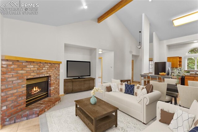 living room featuring beamed ceiling, a brick fireplace, and high vaulted ceiling