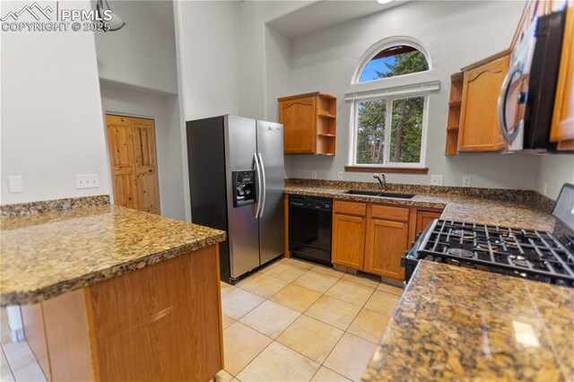 kitchen featuring black appliances, open shelves, a sink, brown cabinetry, and light tile patterned flooring