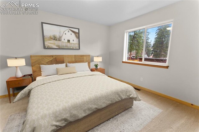 carpeted bedroom featuring baseboards
