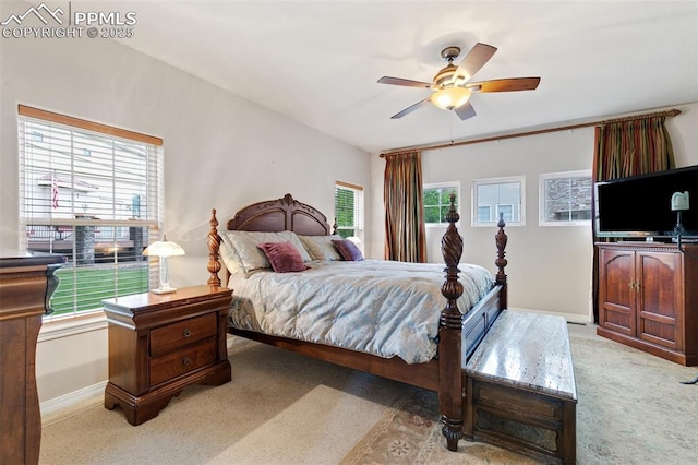carpeted bedroom with baseboards and a ceiling fan
