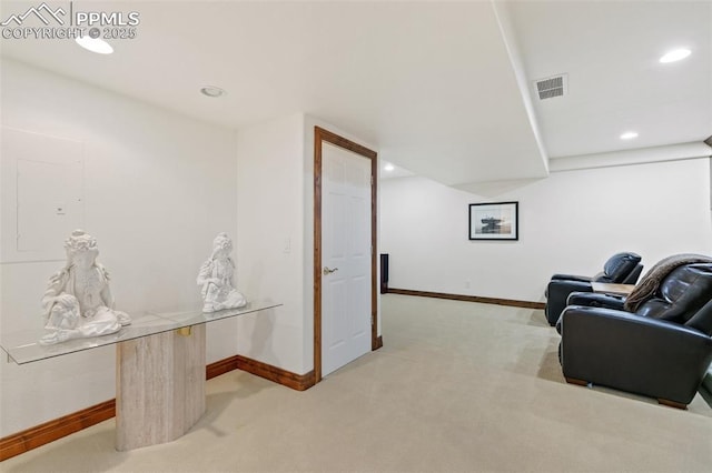 living area featuring light colored carpet, baseboards, and recessed lighting