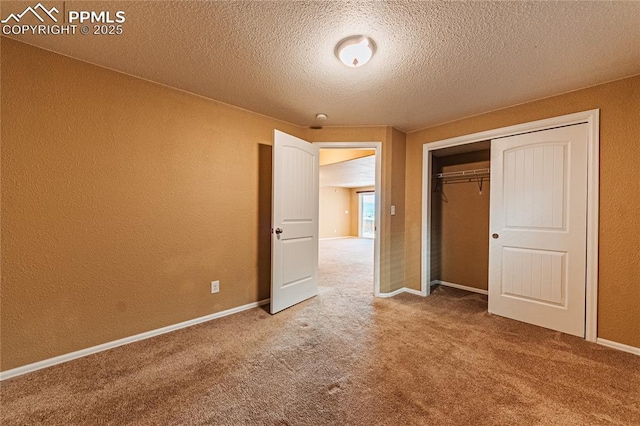 6018 Cumbre Vista Way, Colorado Springs, CO 80924 - unfurnished bedroom featuring carpet, a textured ceiling, a textured wall, a closet, and baseboards