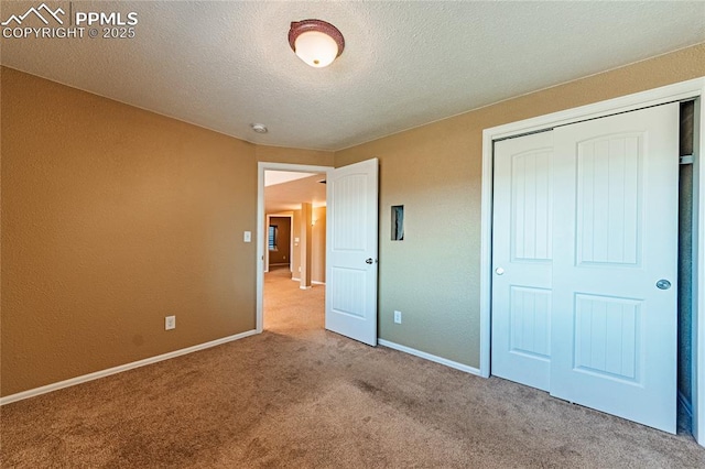 6018 Cumbre Vista Way, Colorado Springs, CO 80924 - unfurnished bedroom featuring carpet flooring, a closet, baseboards, and a textured ceiling