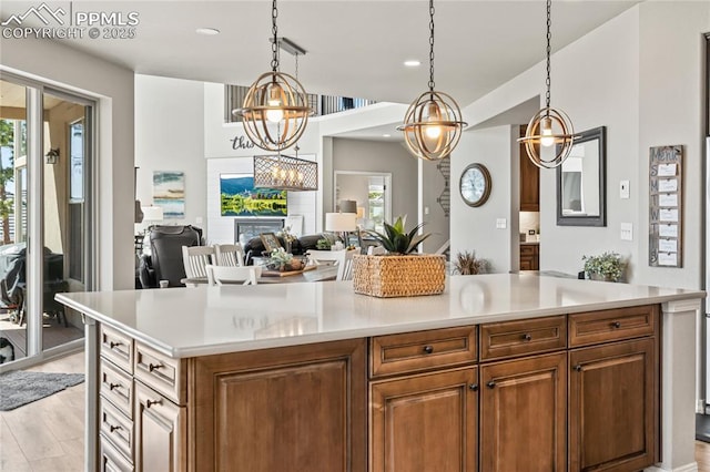 16231 Thunder Cat Way, Monument, CO 80132 - kitchen with light countertops, hanging light fixtures, light wood finished floors, and recessed lighting