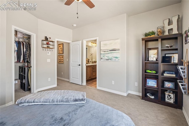 16231 Thunder Cat Way, Monument, CO 80132 - bedroom featuring light carpet, a walk in closet, and baseboards