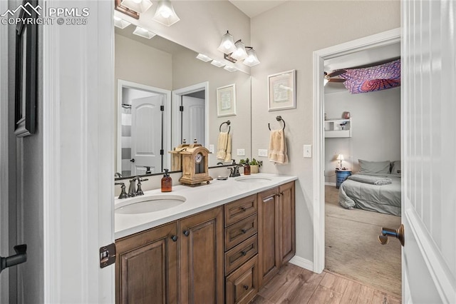 16231 Thunder Cat Way, Monument, CO 80132 - ensuite bathroom featuring double vanity and wood finished floors