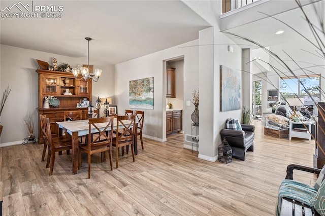 16231 Thunder Cat Way, Monument, CO 80132 - dining room featuring a chandelier, light wood finished floors, and baseboards