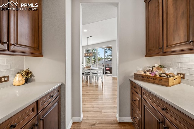 16231 Thunder Cat Way, Monument, CO 80132 - bar with wood finished floors, tasteful backsplash, and baseboards