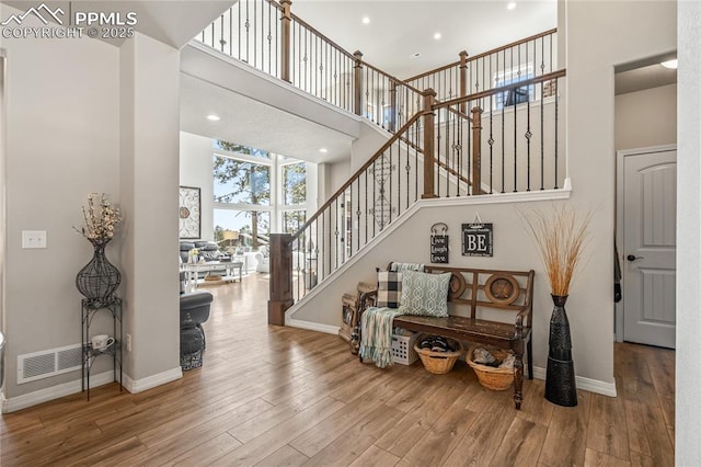 16231 Thunder Cat Way, Monument, CO 80132 - stairs with a towering ceiling, wood finished floors, baseboards, and recessed lighting