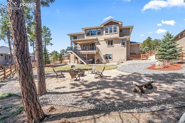 16231 Thunder Cat Way, Monument, CO 80132 - back of property with stairs, an outdoor fire pit, stucco siding, and fence