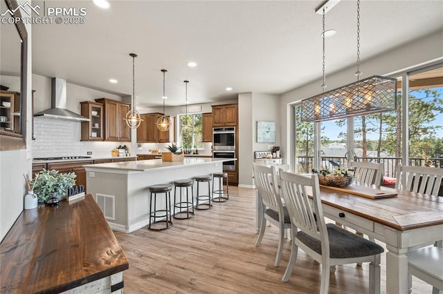 16231 Thunder Cat Way, Monument, CO 80132 - dining area featuring recessed lighting, plenty of natural light, light wood-style floors, and baseboards