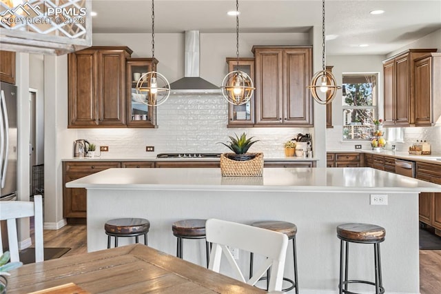 16231 Thunder Cat Way, Monument, CO 80132 - kitchen featuring a breakfast bar area, light countertops, a kitchen island, wood finished floors, and recessed lighting
