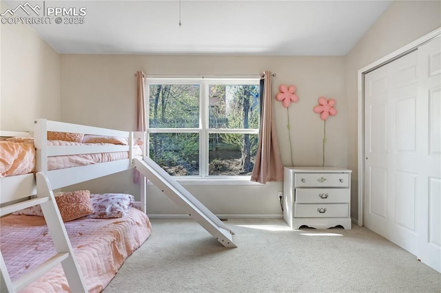 bedroom with carpet floors and baseboards