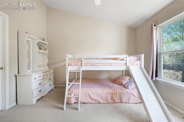 bedroom featuring light carpet and baseboards