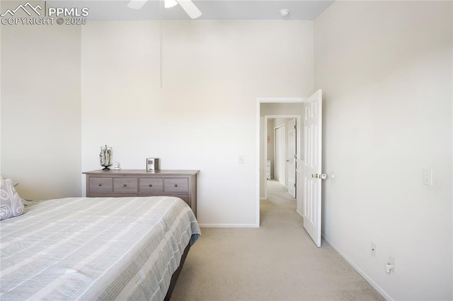 bedroom featuring light carpet, baseboards, and ceiling fan