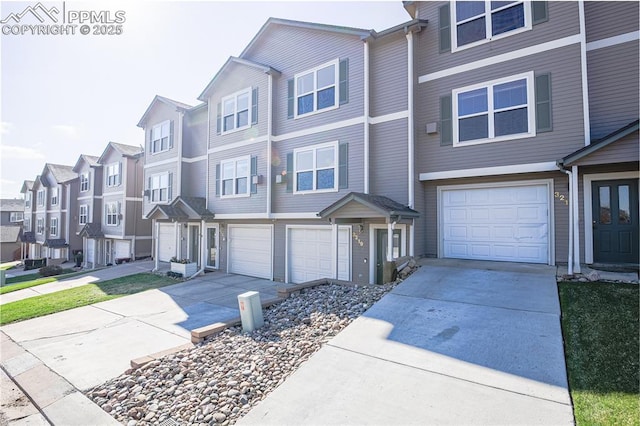townhome / multi-family property featuring an attached garage, driveway, and a residential view