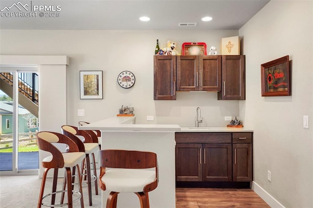 16420 Mountain Glory Dr, Monument, CO 80132 - bar featuring a sink, recessed lighting, baseboards, and light wood-style flooring