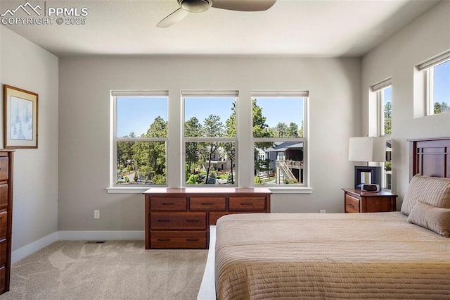 16420 Mountain Glory Dr, Monument, CO 80132 - bedroom featuring baseboards, light carpet, and a ceiling fan