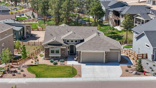 16420 Mountain Glory Dr, Monument, CO 80132 - view of front of house featuring a garage, driveway, fence, and a residential view