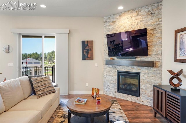 16420 Mountain Glory Dr, Monument, CO 80132 - living room featuring wood finished floors, a stone fireplace, recessed lighting, and baseboards