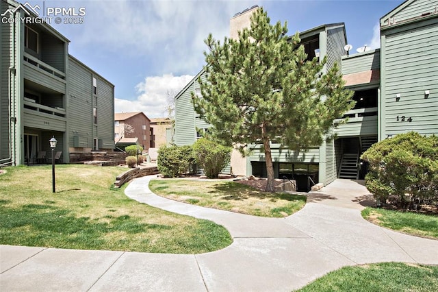 124 W Rockrimmon Blvd Unit 103, Colorado Springs, CO 80919 - surrounding community featuring a lawn, stairway, and a residential view