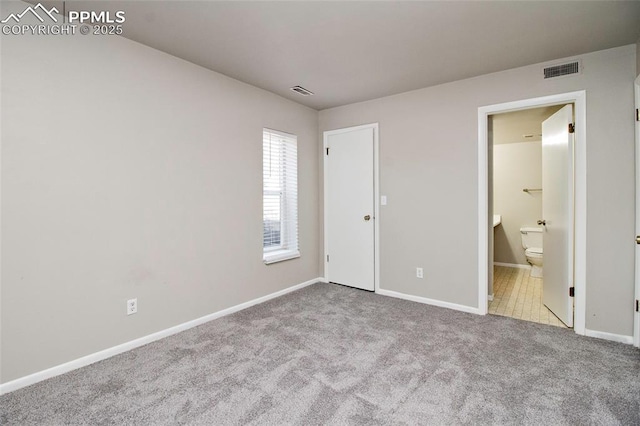 124 W Rockrimmon Blvd Unit 103, Colorado Springs, CO 80919 - unfurnished bedroom with carpet floors, baseboards, and ensuite bathroom