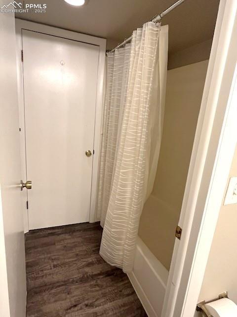 124 W Rockrimmon Blvd Unit 103, Colorado Springs, CO 80919 - bathroom with wood finished floors and shower / bath combo with shower curtain