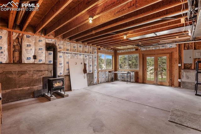 16 Echo Cir, Florissant, CO 80816 - miscellaneous room featuring concrete floors, a wood stove, and electric panel