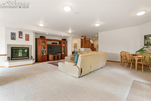 17575 Minglewood Trl, Monument, CO 80132 - carpeted living area with stairway, a tile fireplace, baseboards, and recessed lighting
