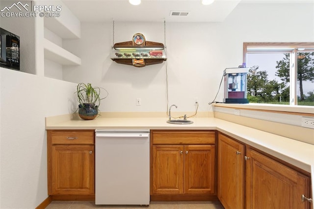 17575 Minglewood Trl, Monument, CO 80132 - kitchen featuring white dishwasher, a sink, brown cabinetry, light countertops, and recessed lighting