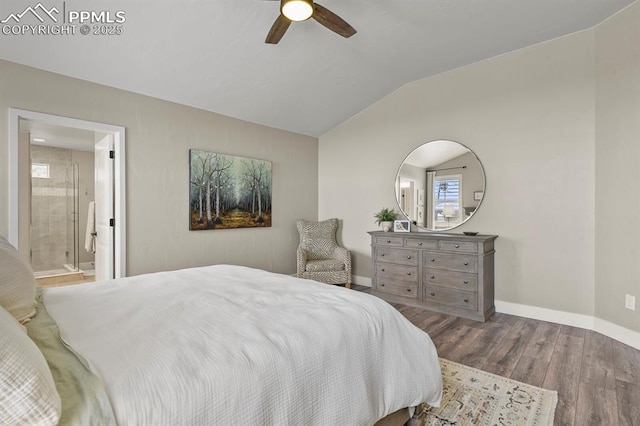 bedroom featuring wood finished floors, vaulted ceiling, baseboards, ensuite bath, and ceiling fan